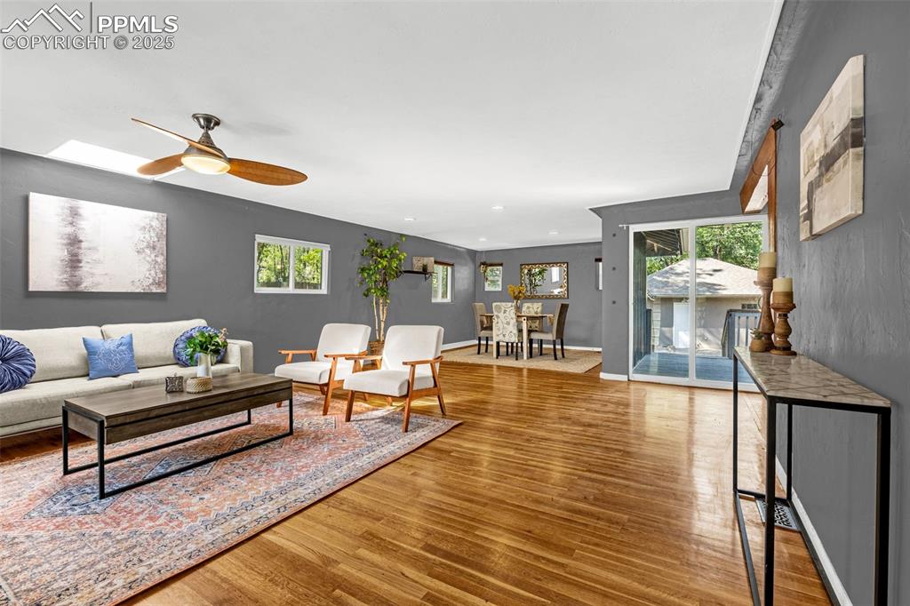 Image 6 of 42: Living room featuring wood finished floors, a ceiling fan, and recessed lig