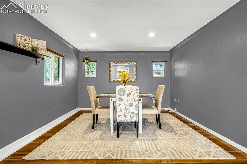Image 9 of 42: Dining room featuring dark wood-style floors, plenty of natural light, and 
