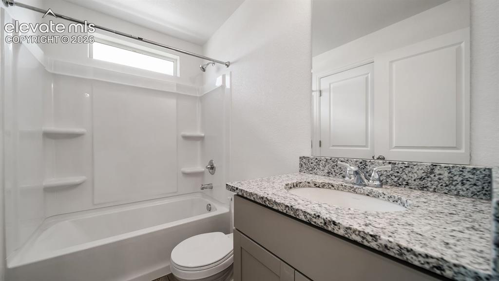 Image 13 of 17: Tub/shower combination with a transom window, chrome fixtures, and built-in
