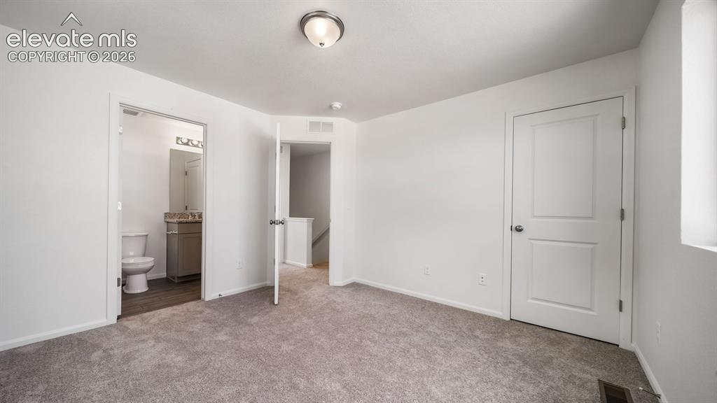 Image 14 of 17: Carpeted flooring, white walls, and a window for natural light
*photos of