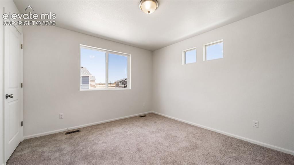 Image 15 of 17: Neutral toned walls and carpeting, white trim, recessed lighting, and multi