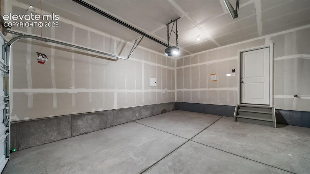 Image 5 of 17: Concrete flooring with a white paneled door and integrated steps
*photos o