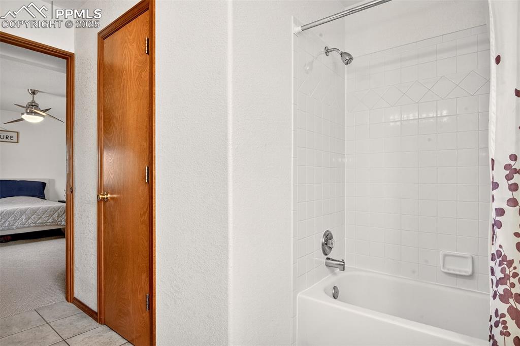 Image 16 of 40: Full bath with shower / tub combo, ensuite bathroom, tile patterned floorin