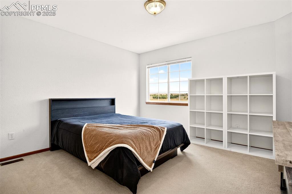 Image 19 of 40: Upper level Carpeted bedroom with baseboards