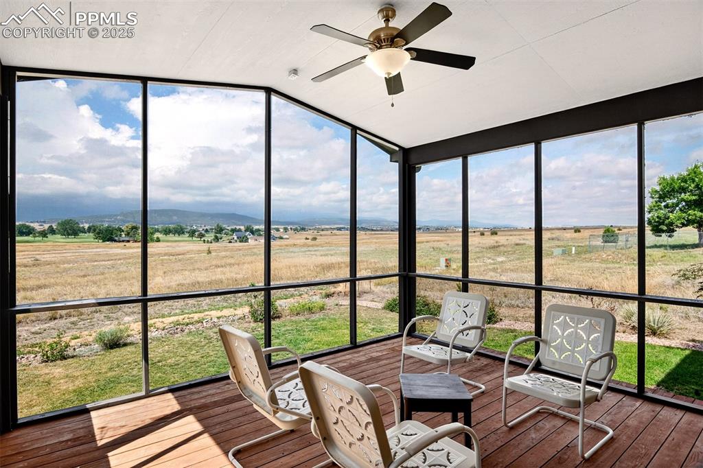 Image 31 of 40: Sunroom featuring a view of countryside, a ceiling fan, healthy amount of n