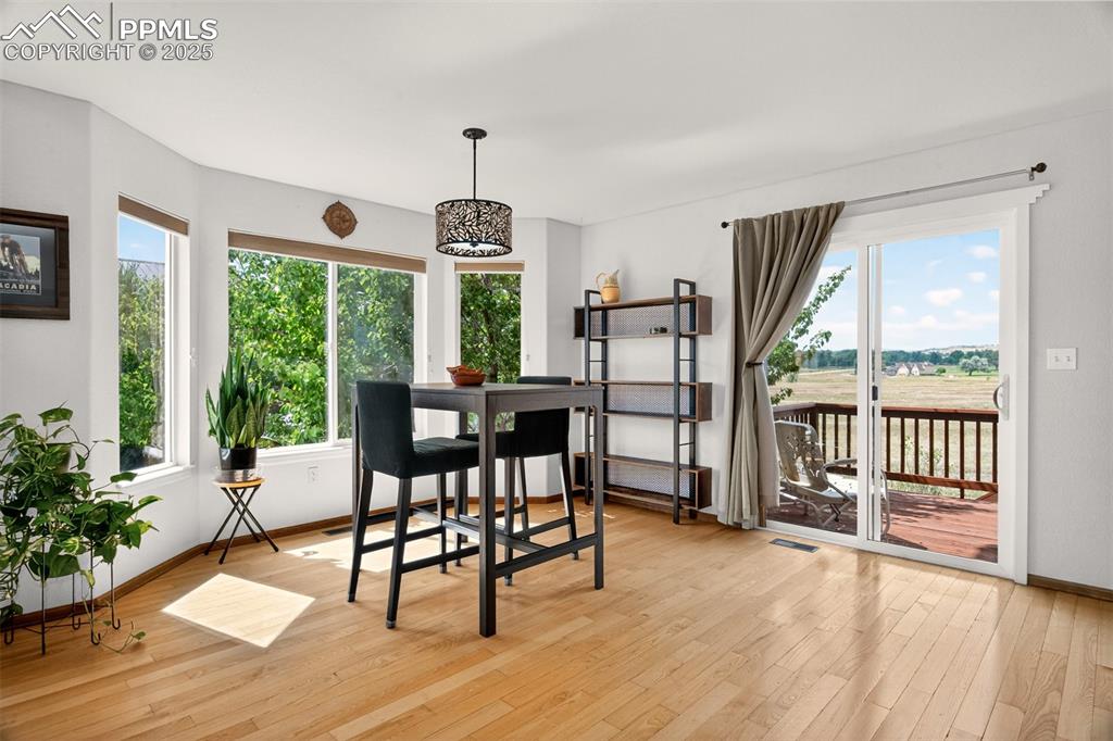 Image 8 of 40: Dining area featuring light wood-type flooring and baseboards