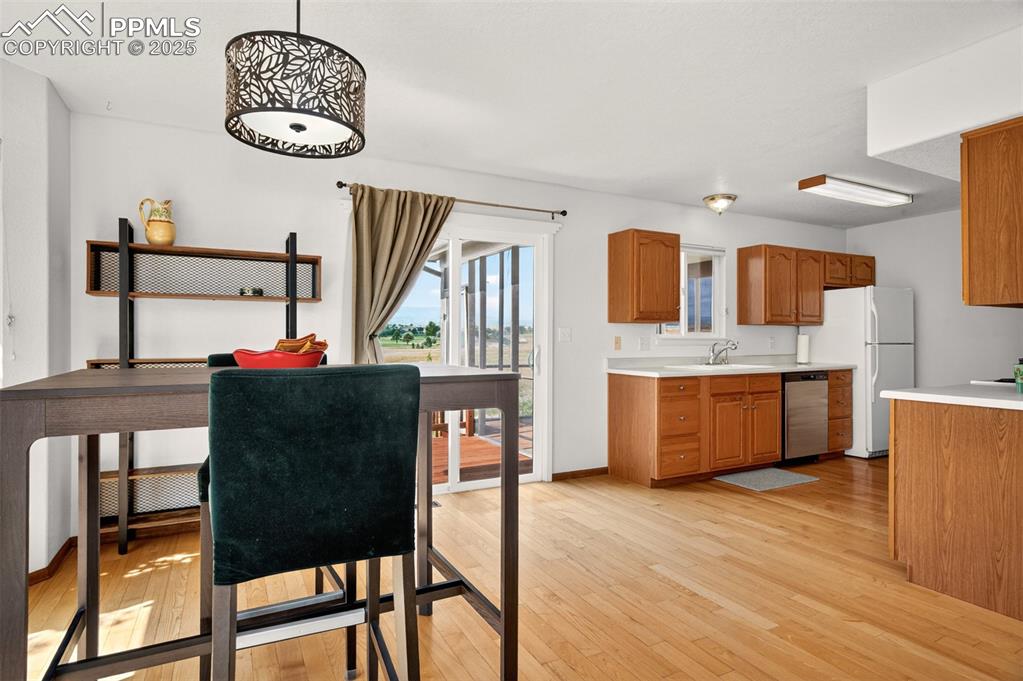 Image 9 of 40: Dining room with light wood-type flooring and baseboards