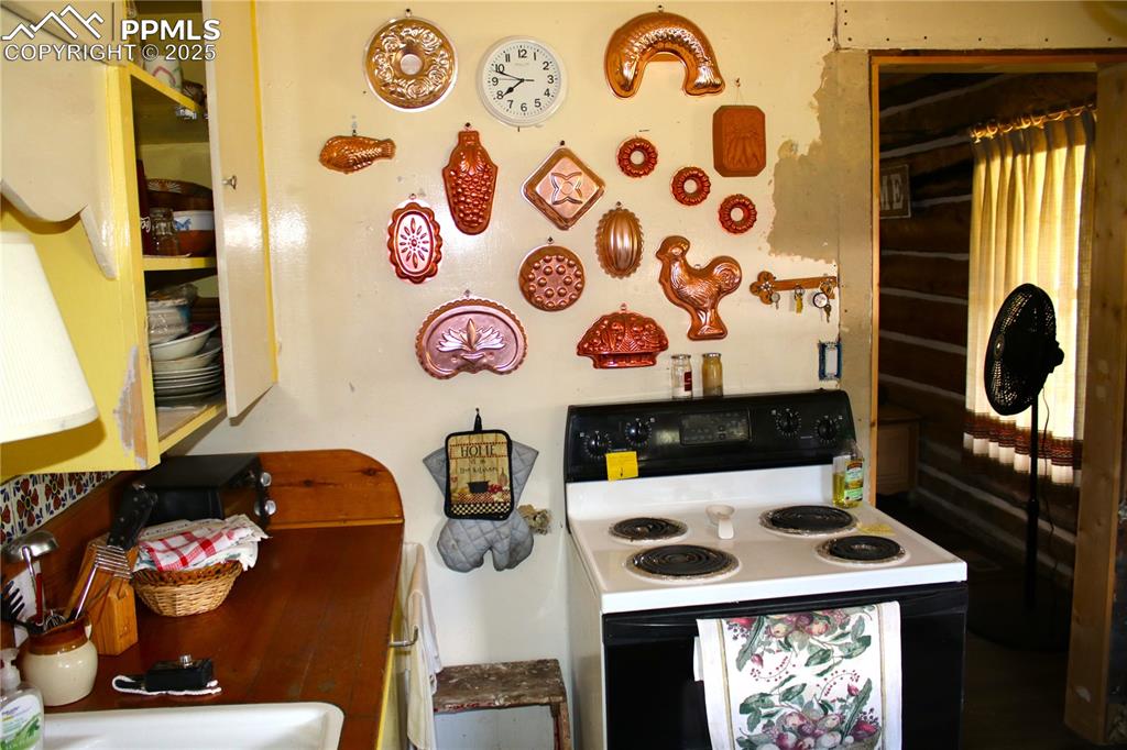 Image 22 of 28: Kitchen with white electric range