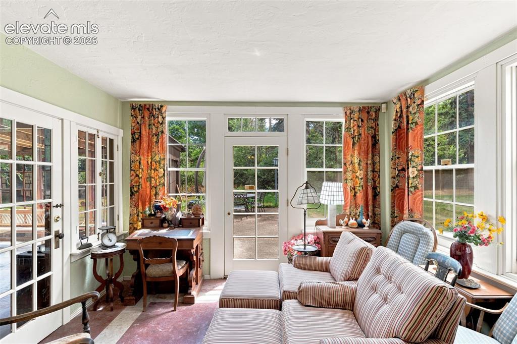 Image 22 of 50: Sunroom off Music Room with walkout to back patio