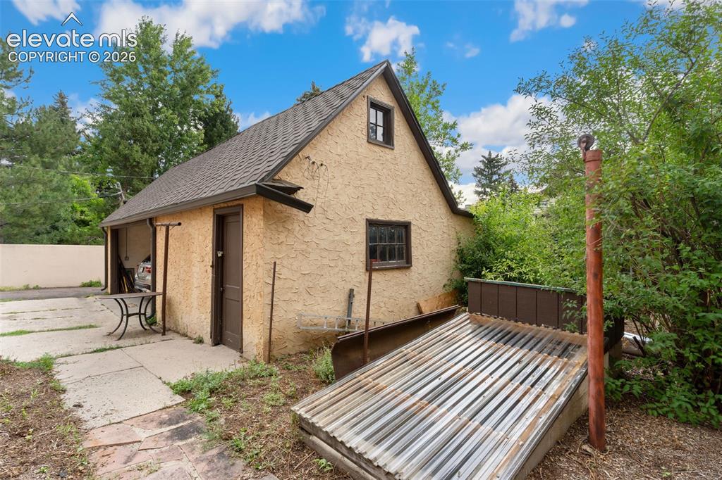 Image 50 of 50: Garage with Storm cellar next to it