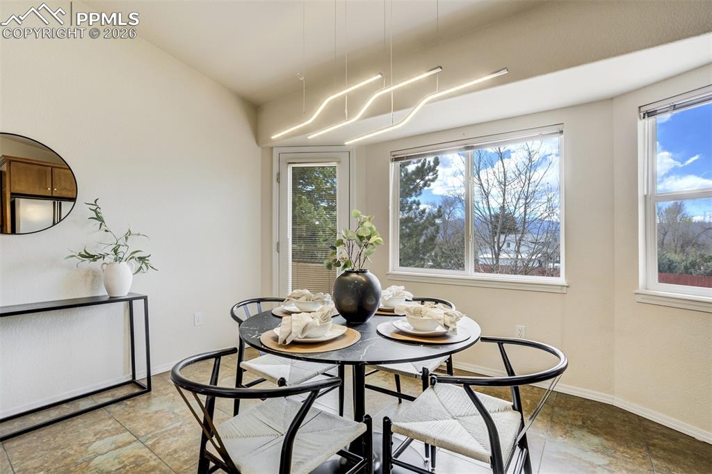 Image 12 of 39: Large windows in the eat-in dining room with a wall of windows to enjoy the