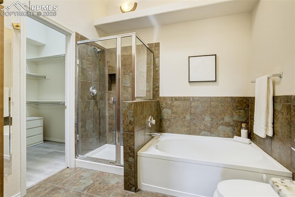 Image 22 of 39: Standing shower with a separate soaking tub. 