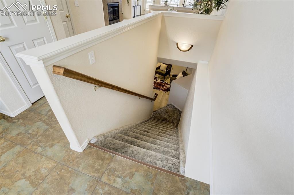 Image 25 of 39: Head downstairs to the finished basement. 