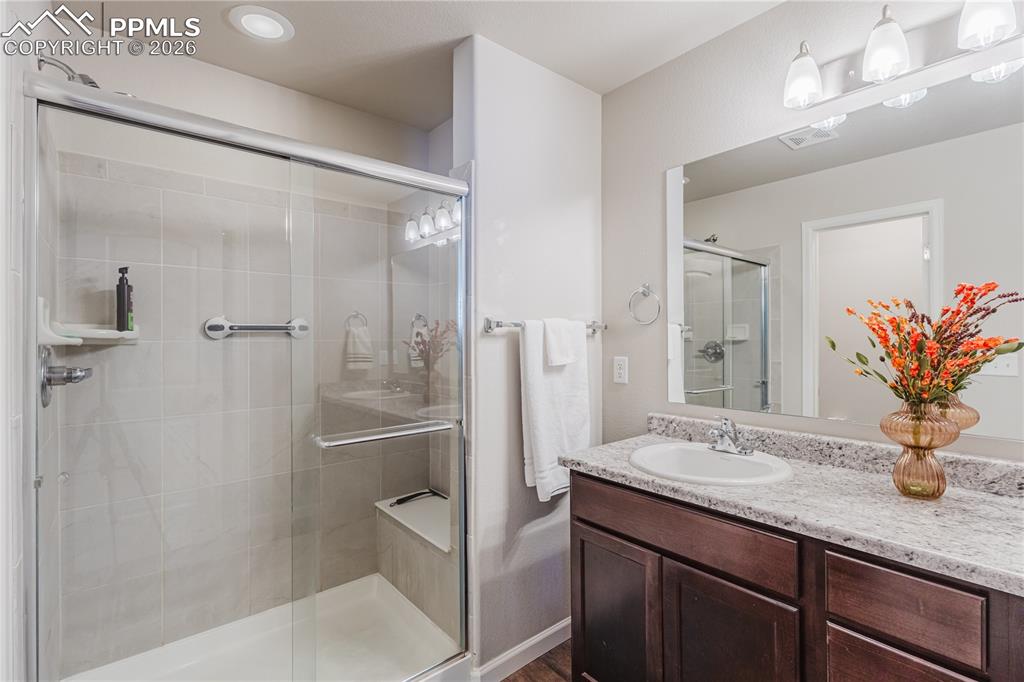 Image 13 of 26: Bedroom with light carpet and a ceiling fan