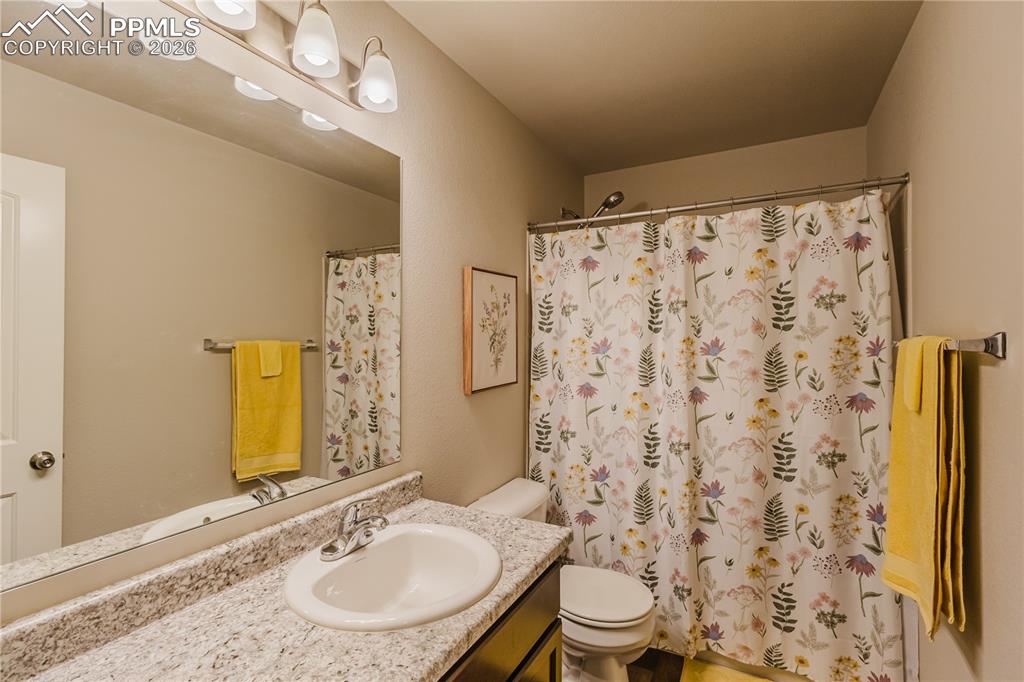 Image 16 of 26: Bedroom with ceiling fan and carpet flooring