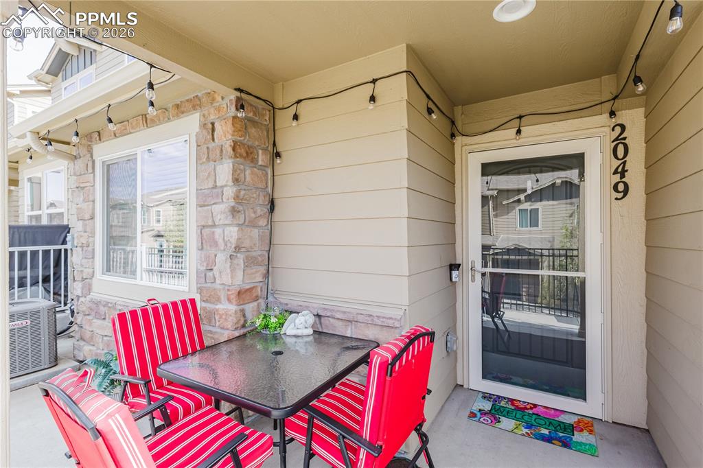 Image 3 of 26: Craftsman-style house with roof with shingles, stone siding, a fenced front