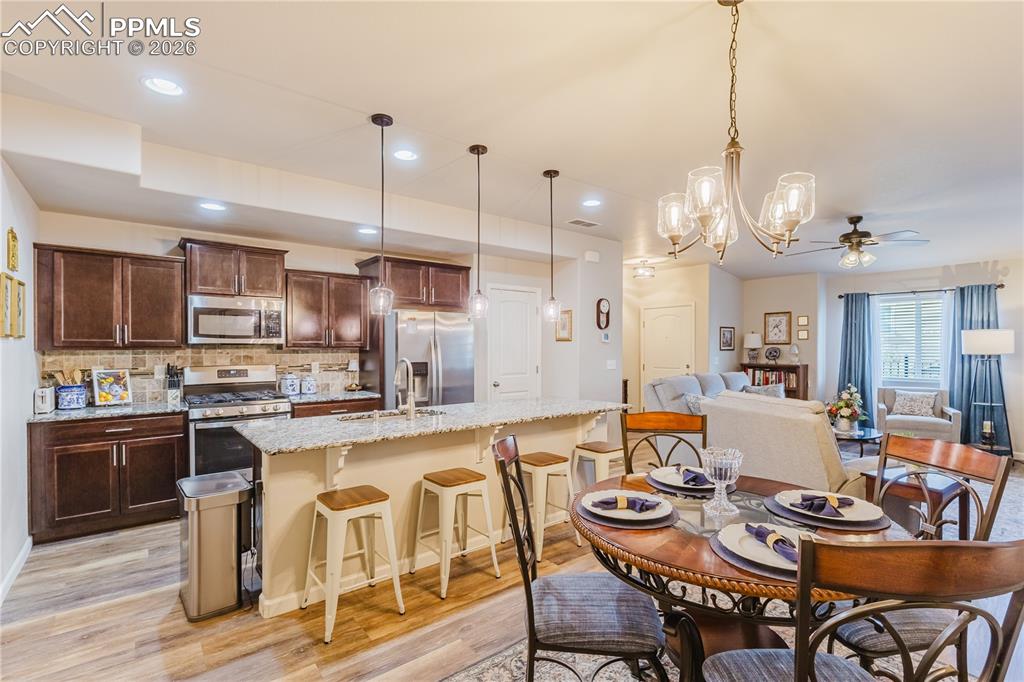 Image 9 of 26: Kitchen featuring stainless steel appliances, hanging light fixtures, light
