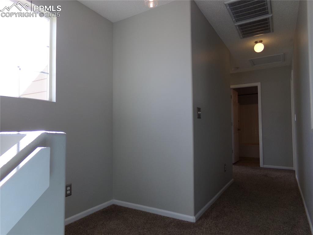 Image 14 of 29: Corridor featuring carpet flooring and baseboards