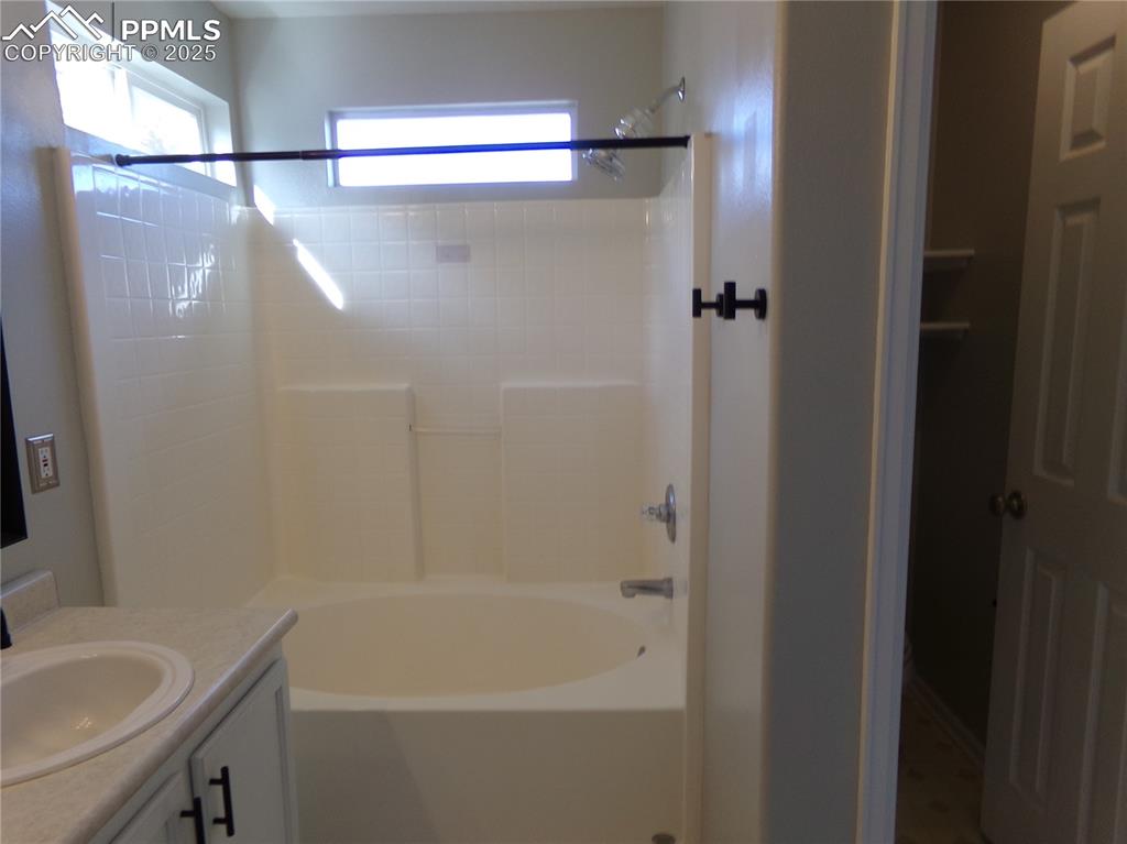 Image 19 of 29: Full bathroom with shower combination and vanity