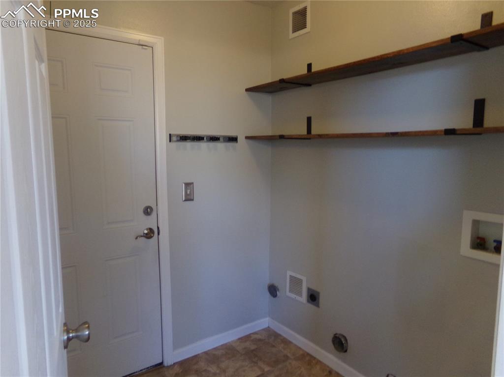 Image 25 of 29: Laundry room with hookup for a washing machine and baseboards