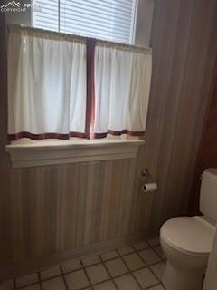 Image 13 of 50: Bathroom featuring toilet and light tile patterned floors