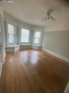 Image 14 of 50: Hardwood flooring and a ceiling fan