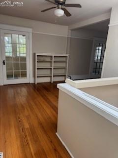 Image 45 of 50: Hall with dark wood-style flooring