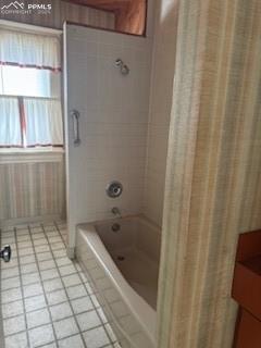 Image 47 of 50: Full bathroom featuring light tile patterned floors and shower / bathtub co