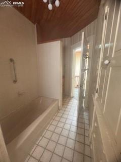 Image 49 of 50: Full bathroom featuring wood ceiling and light tile patterned flooring