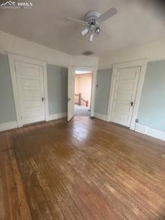 Image 50 of 50: Unfurnished bedroom with wood finished floors and a ceiling fan