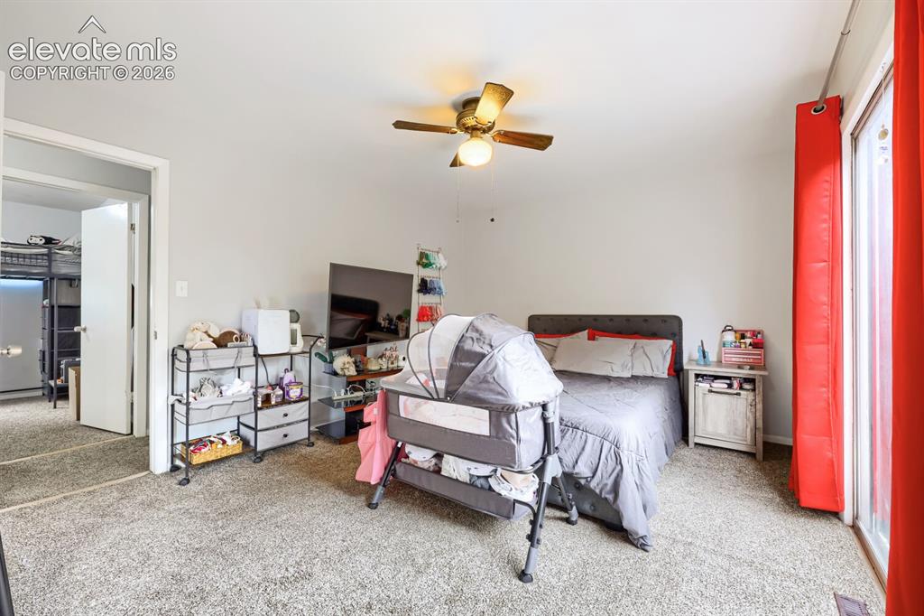 Image 10 of 26: Carpet flooring and a ceiling fan with integrated lighting