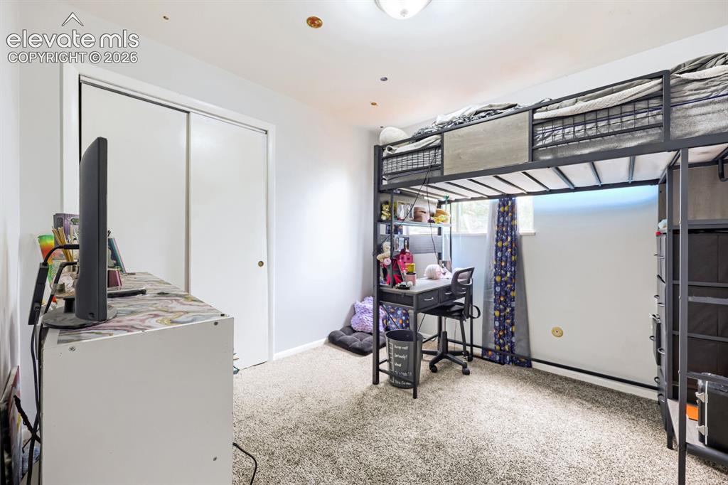 Image 14 of 26: Carpeted flooring, white walls, and a single light fixture on the ceiling