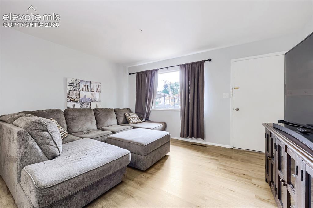 Image 3 of 26: Light-toned wood-finish flooring, white walls, and a white ceiling