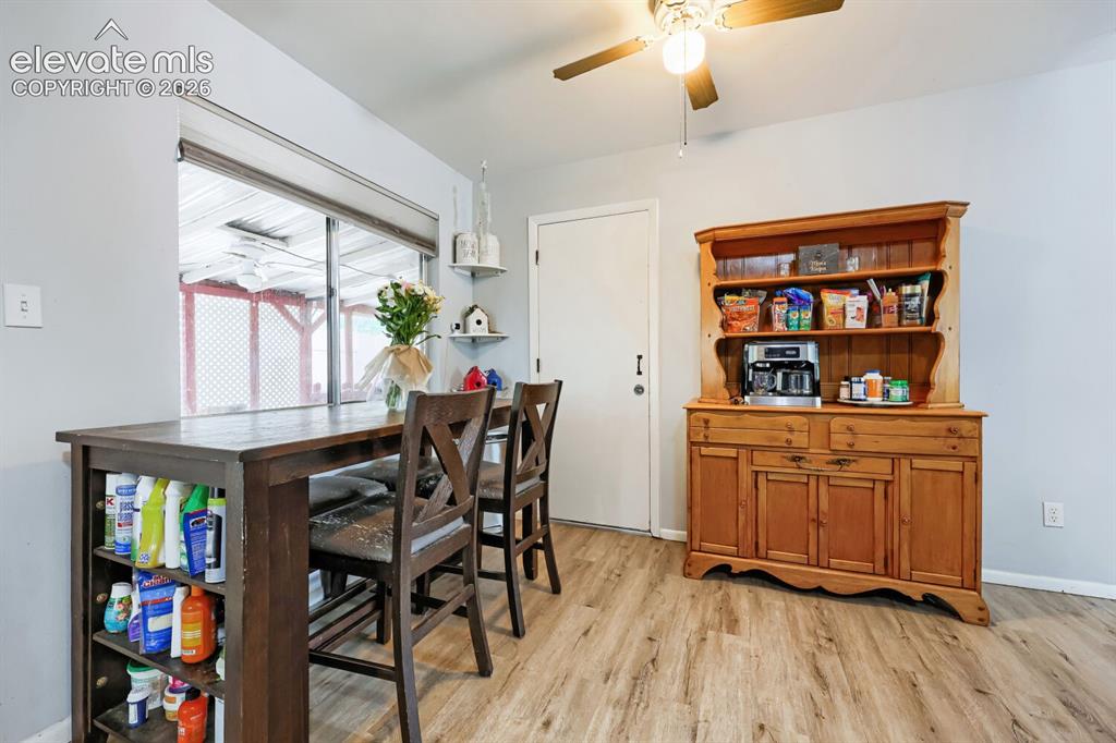 Image 6 of 26: Wood-finish flooring, built-in open shelving, ceiling fan with integrated l