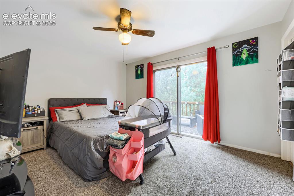 Image 8 of 26: Room featuring neutral wall tones, carpeted flooring, a ceiling fan, and sl