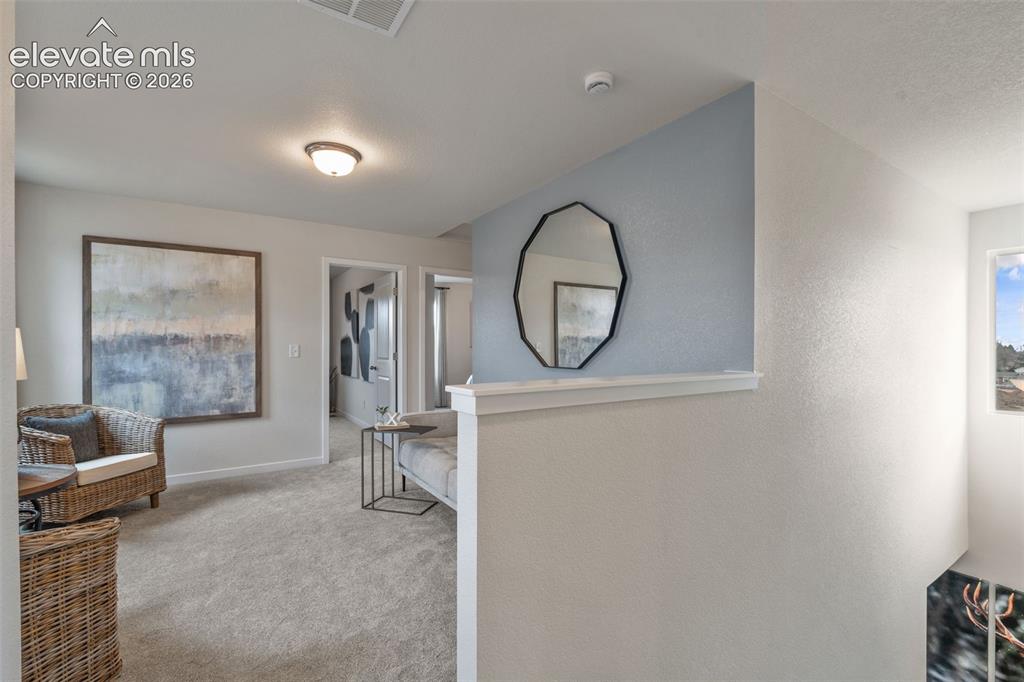 Image 12 of 26: Carpeted flooring, recessed ceiling lighting, light-toned wall finishes, an