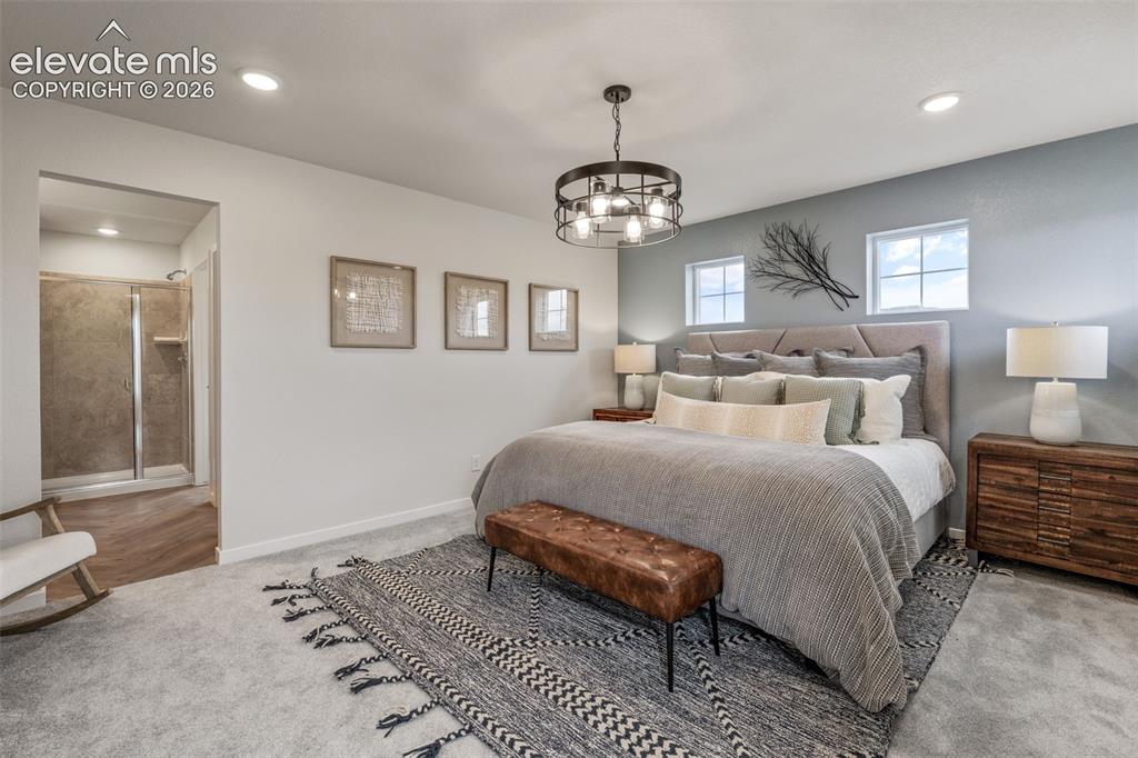 Image 16 of 26: Plush carpeting throughout, complemented by recessed lighting and a contemp