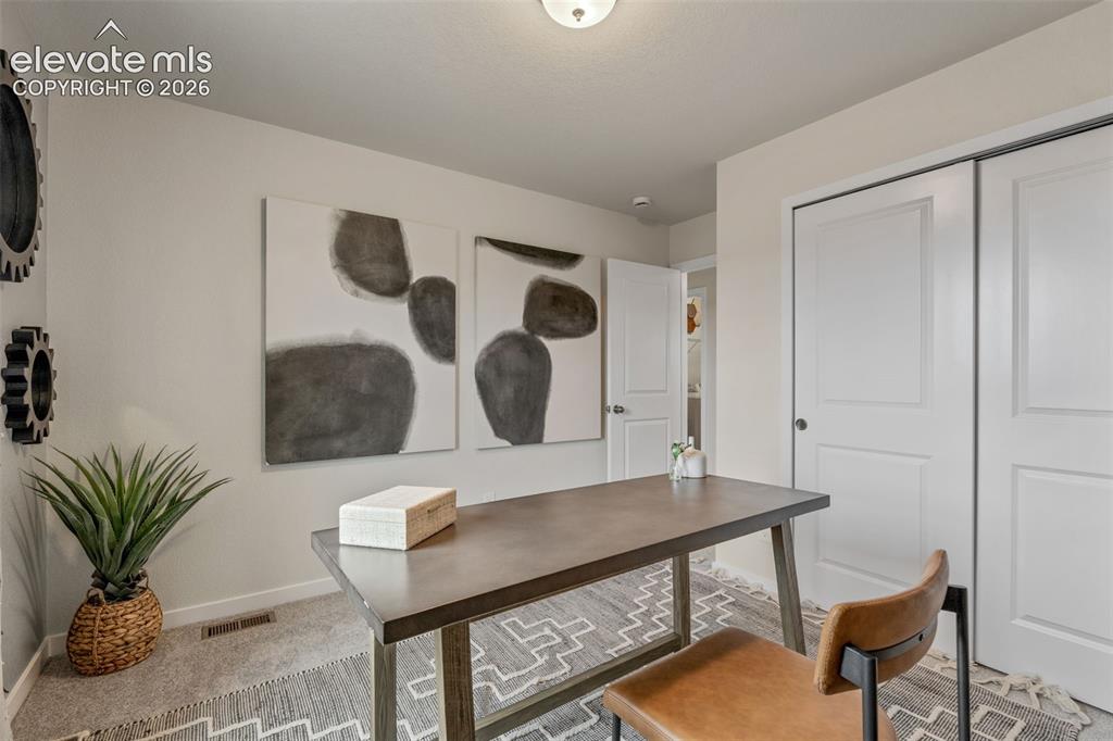 Image 25 of 26: Recessed lighting, light gray wall paint, carpeting, and white paneled door
