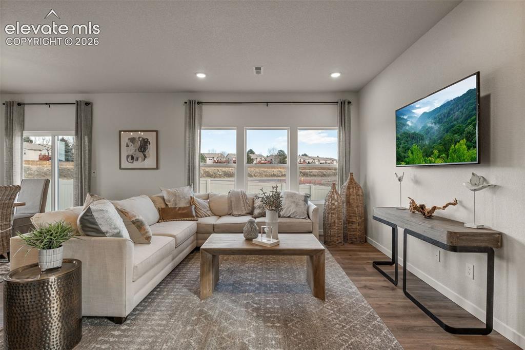 Image 3 of 26: Recessed lighting, wood-finish flooring, and multiple windows