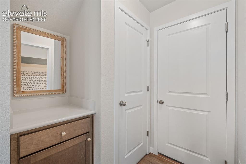 Image 9 of 26: Built-in wood-finish cabinetry with a light-toned countertop
