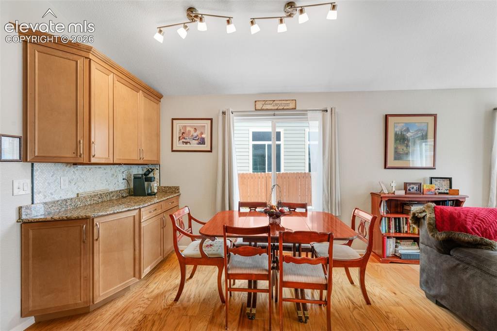 Image 19 of 46: Open Kitchen with granite countertops, stainless steel appliances, island/b