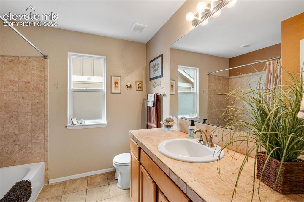 Image 30 of 46: Upper bedroom with front of house window, deep/long closet and oak flooring