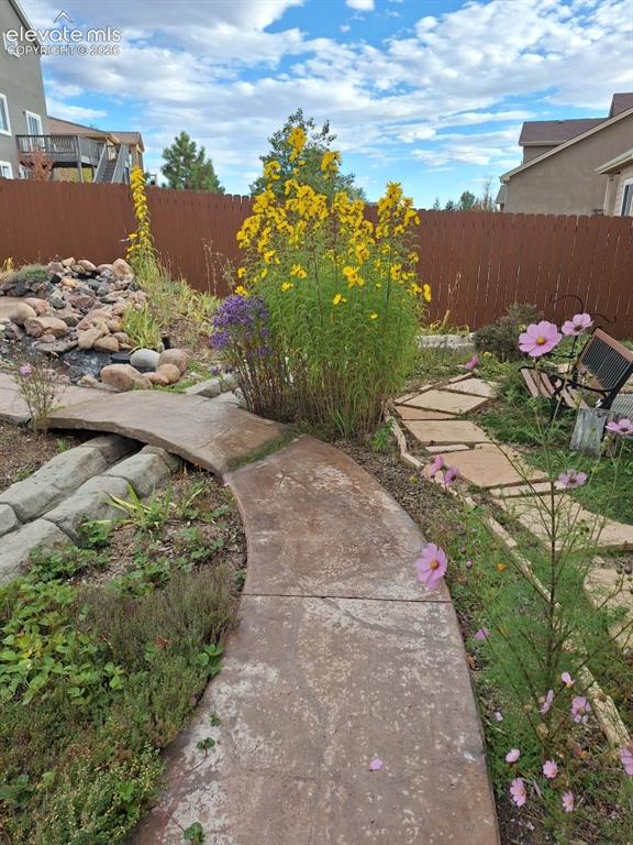 Image 7 of 46: Built-in firepit for and water feature