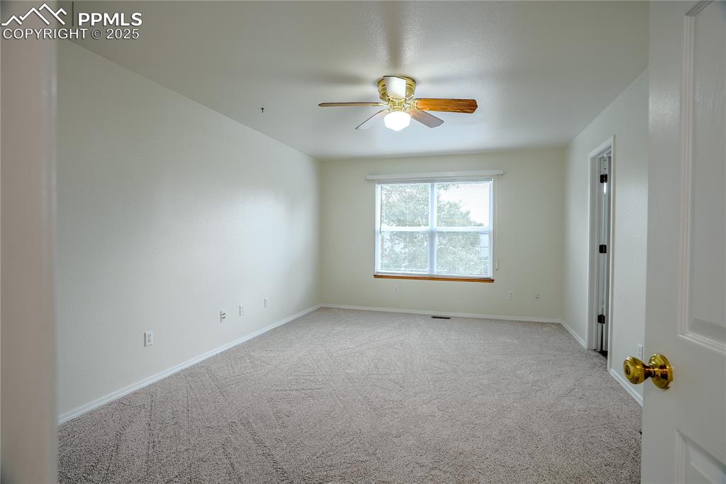Image 12 of 37: Primary bedroom with ceiling fan