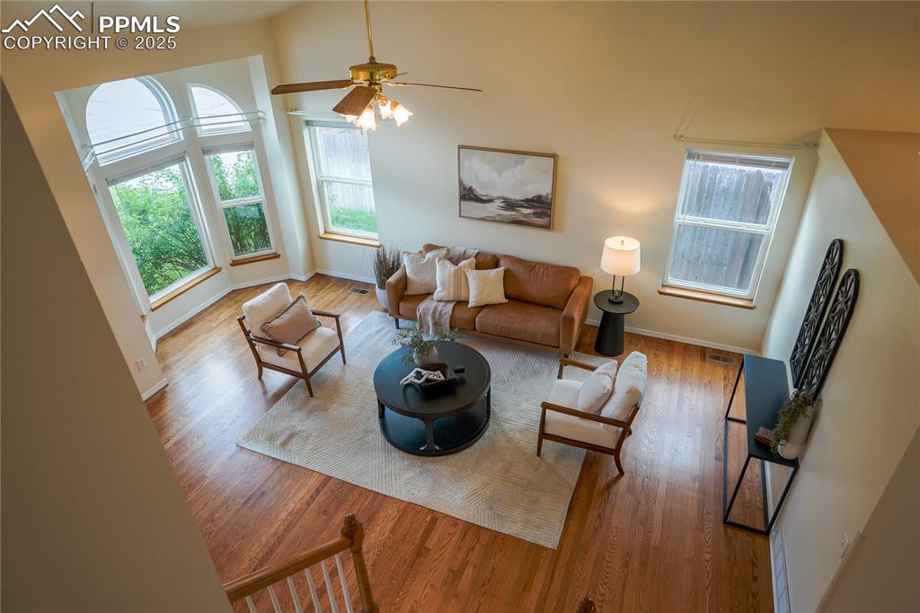 Image 16 of 37: Living room with wood finished floors, healthy amount of natural light, and