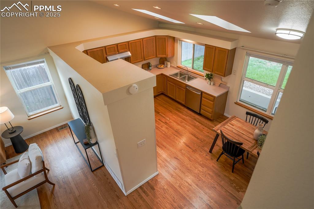 Image 18 of 37: Kitchen with light countertops, light wood finished floors, stainless steel