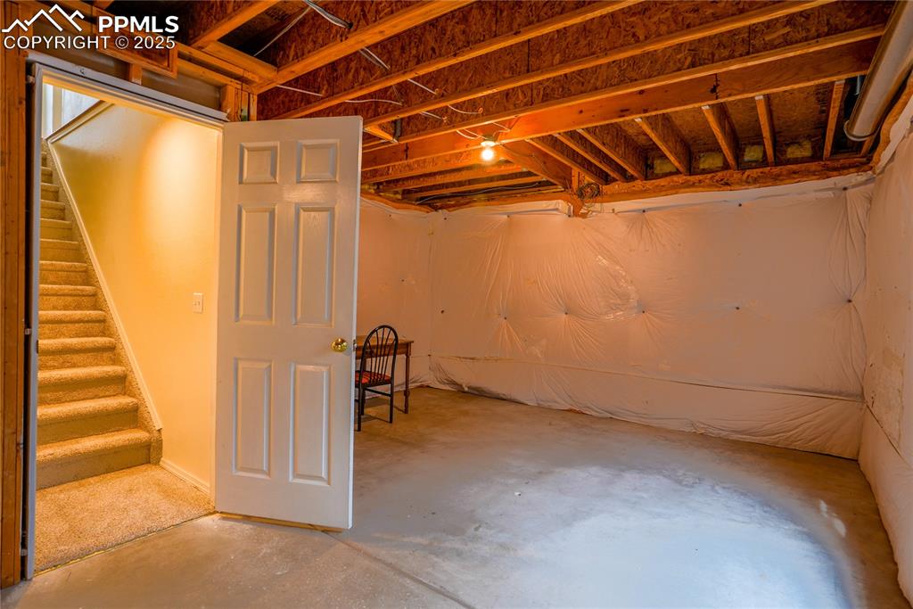 Image 29 of 37: Unfinished below grade area with stairway