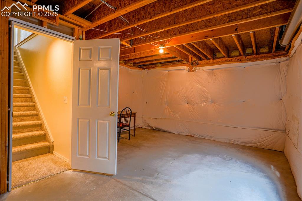 Image 29 of 37: Unfinished below grade area with stairway