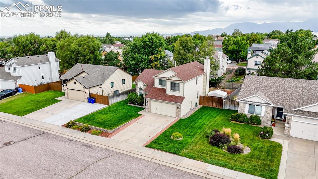 Image 32 of 37: Aerial perspective of suburban area featuring a mountain backdrop