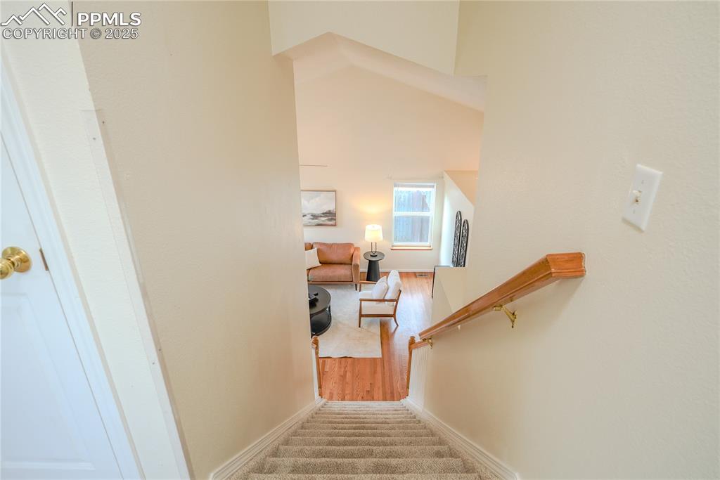 Image 5 of 37: Staircase featuring carpet floors and a high ceiling
